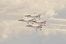 a group of fighter jets are flying in formation and one of them has the letters seaf on the side of it