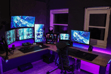 a computer desk with multiple monitors and a speaker that says sony