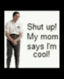 a man is standing in front of a sign that says `` shut up my mom says i 'm cool '' .