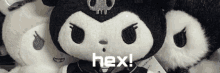 a group of stuffed animals are sitting next to each other with the words hex written on the bottom .