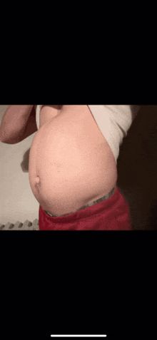 a pregnant woman 's belly is shown in a close up