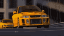 a yellow car is driving down a road with other cars
