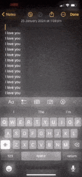 a phone screen shows a note that says i love you at the top