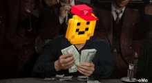 a man with a pixelated face on his head is holding a bunch of money