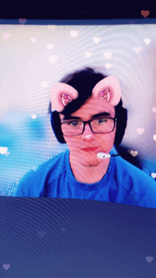 a man wearing glasses and headphones has a cat ear mask on his face