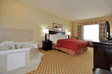 a hotel room with a king size bed and a jacuzzi