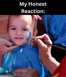 a baby is getting his face painted with the words my honest reaction