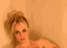 britney spears is taking a bath without a shirt on .