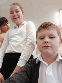 a boy and two girls are standing next to each other