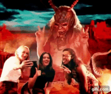 a group of women are posing for a picture in front of a devil .