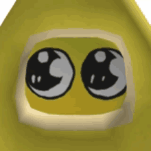 a close up of a yellow object with cartoon eyes