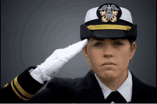 a woman in a military uniform salutes with her hand on her head