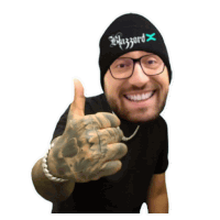 a man wearing a black beanie with the word blizzard on it gives a thumbs up