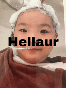 a picture of a baby with the word hellaur written on it