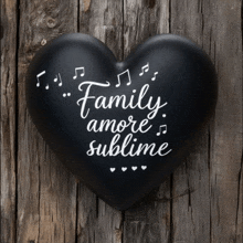 a black heart with the words " family amore sublime " on it