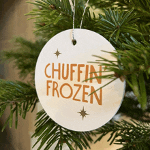 a christmas ornament that says chuffin frozen hangs on a tree