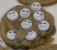 a close up of a cookie with a bunch of faces on it