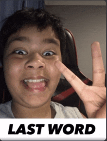 a young boy giving a peace sign with the words last word behind him