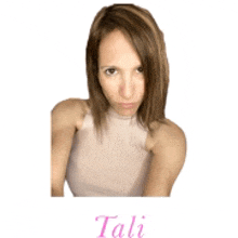 a woman in a white tank top with the name tali written on the bottom