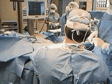 a group of surgeons are performing surgery in an operating room