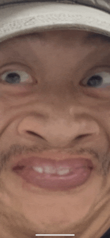 a close up of a man 's face making a funny face