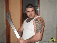 a man with a tattoo on his arm is holding a machete in his hand .