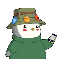 a penguin wearing a hat and sweater is holding a cellphone