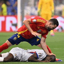 two soccer players one in a red jersey with the number 9 on it