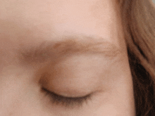 a close up of a person 's eye with their eye closed