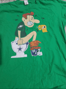 a green t-shirt with a man sitting on a toilet