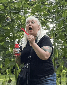 a woman blowing soap bubbles with a bottle that says ' soap bubbles ' on it