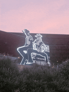 a cowboy and a cowgirl are sitting on the back of a car with the word texas on it