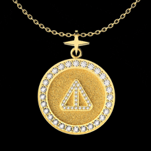 a gold pendant with a triangle in the center and diamonds around it