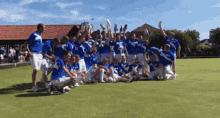 a group of people are posing for a picture and one of them is wearing a shirt that says ' rugby ' on the front