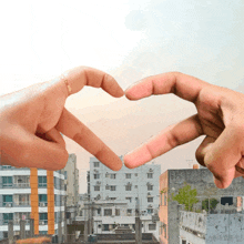 two hands make a heart shape with their fingers