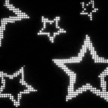 a black background with white dots and stars