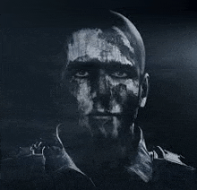 a close up of a man 's face with paint on it in a dark room .