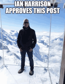 a man stands on top of a snow covered mountain with the caption ian harrison approves this post