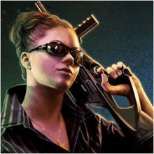 a woman wearing sunglasses is holding a gun in her hand .