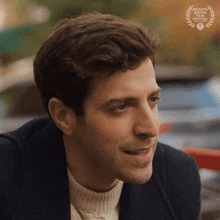 a close up of a man 's face with a laurel wreath behind him that says atlanta independent film festival