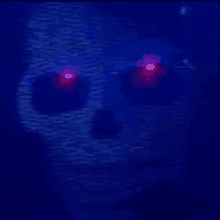 a close up of a person 's face with red eyes in the dark .