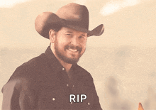 a man wearing a cowboy hat says rip