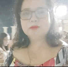 a close up of a woman wearing glasses and a striped shirt