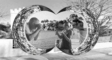 a black and white photo of a man taking a picture and a woman taking a photo