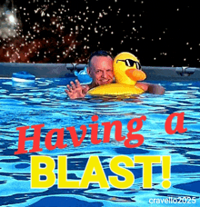 a man is swimming in a pool with a yellow rubber duck and the words having a blast above him