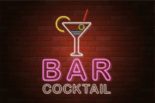 a neon sign for a bar cocktail with a martini glass and a straw on a brick wall .