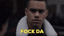 a close up of a man 's face with the words " fock da " in yellow