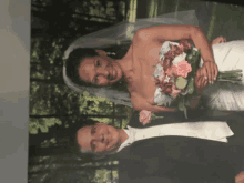 a bride and groom are posing for a picture while the bride is holding a bouquet of flowers