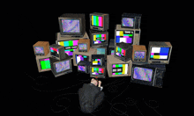 a bunch of televisions are stacked on top of each other and one says game over