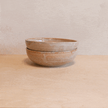 two bowls stacked on top of each other on a table